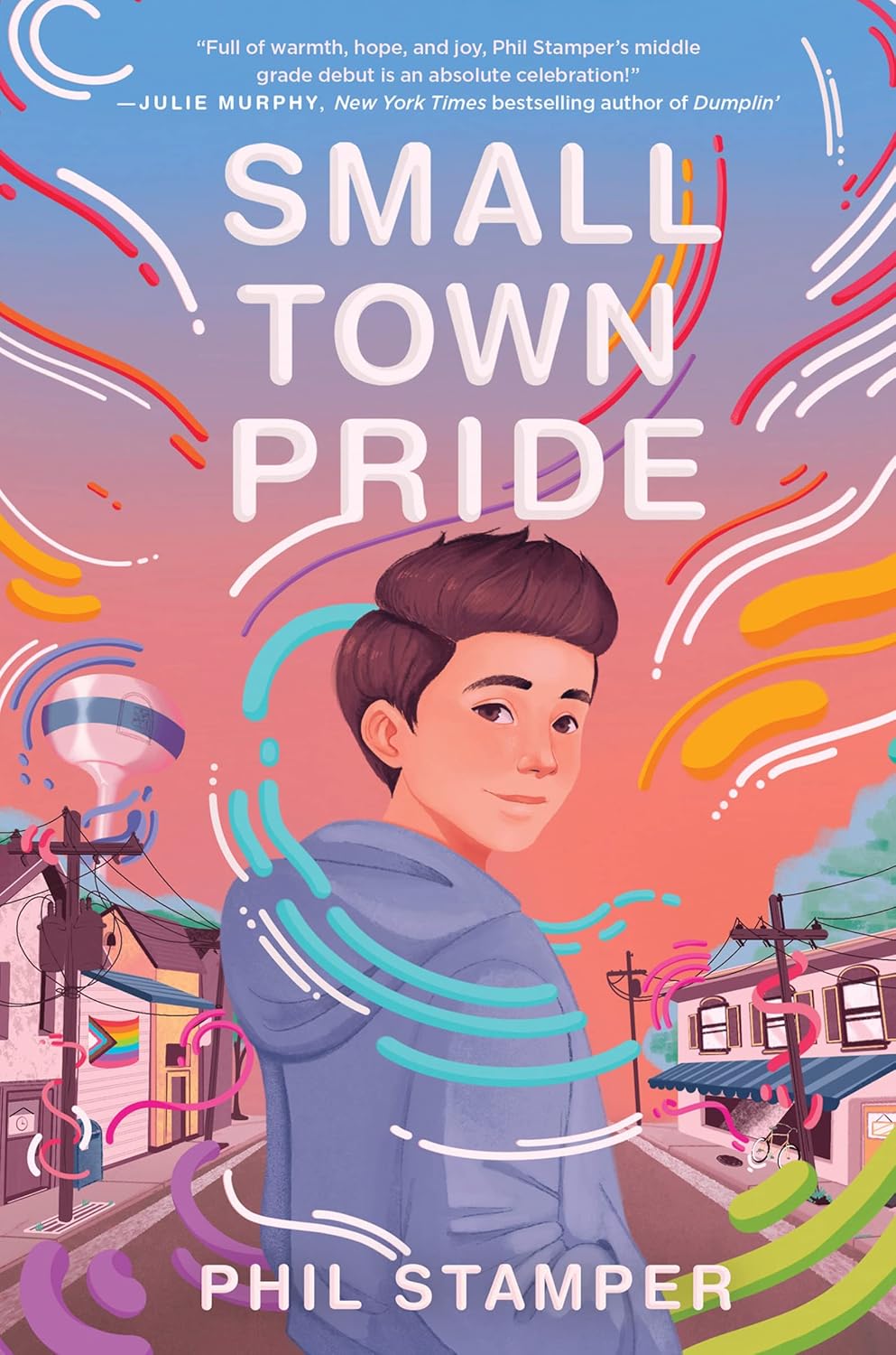 Cover of Small Town Pride: a boy in a hoodie stands on a small-town street surrounded by colorful swirls, a water tower behind him